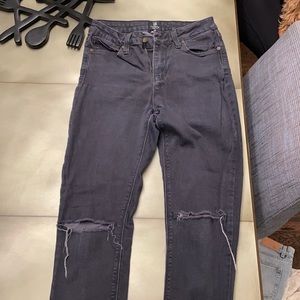 Black jeans with knee slits.